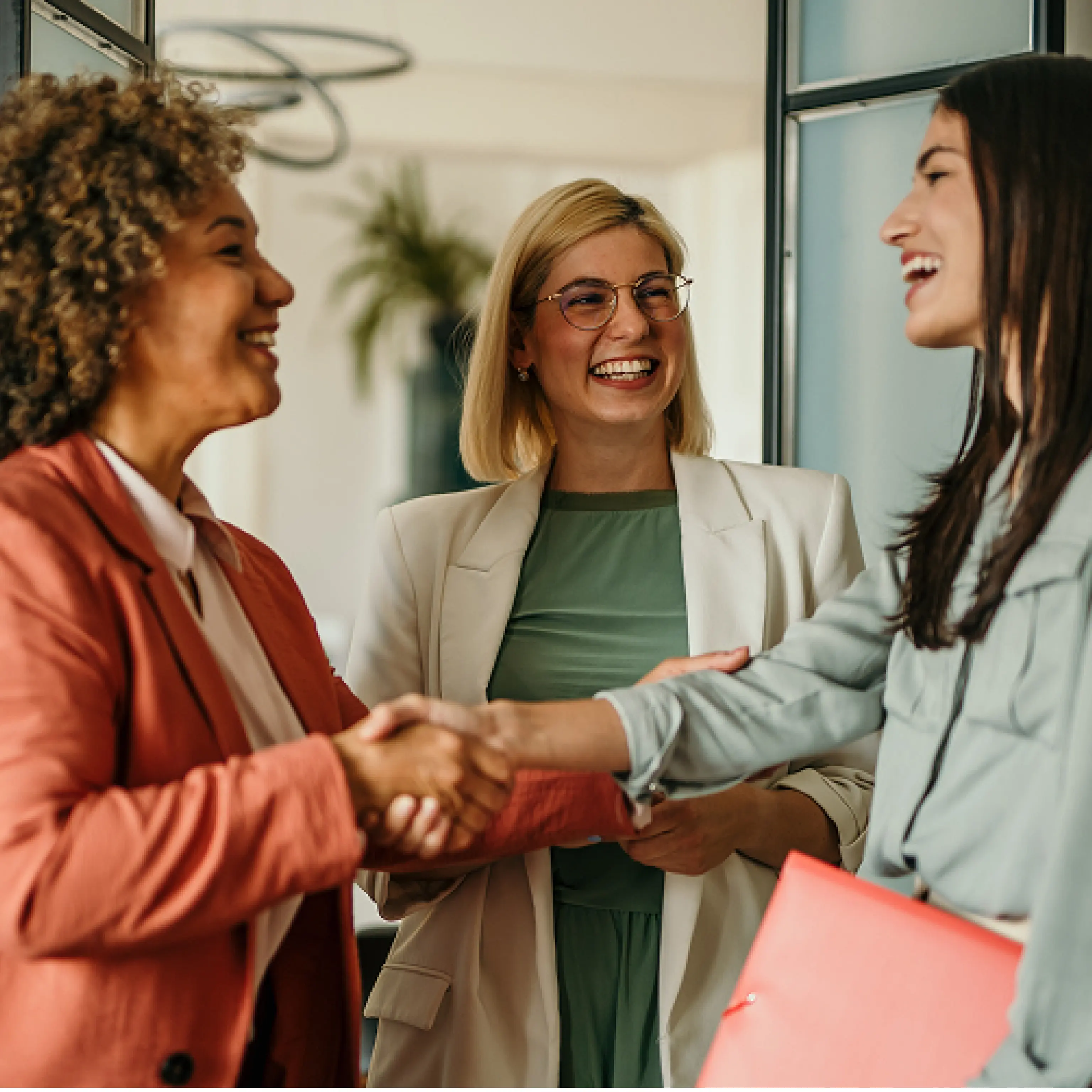About-Deutsche-Bank.png Three professional women smiling and shaking hands in a bright, modern office setting