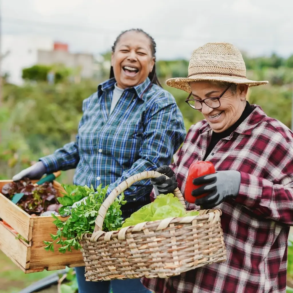 sovereign-bank-about.jpg Image of two women harvesting vegetables
