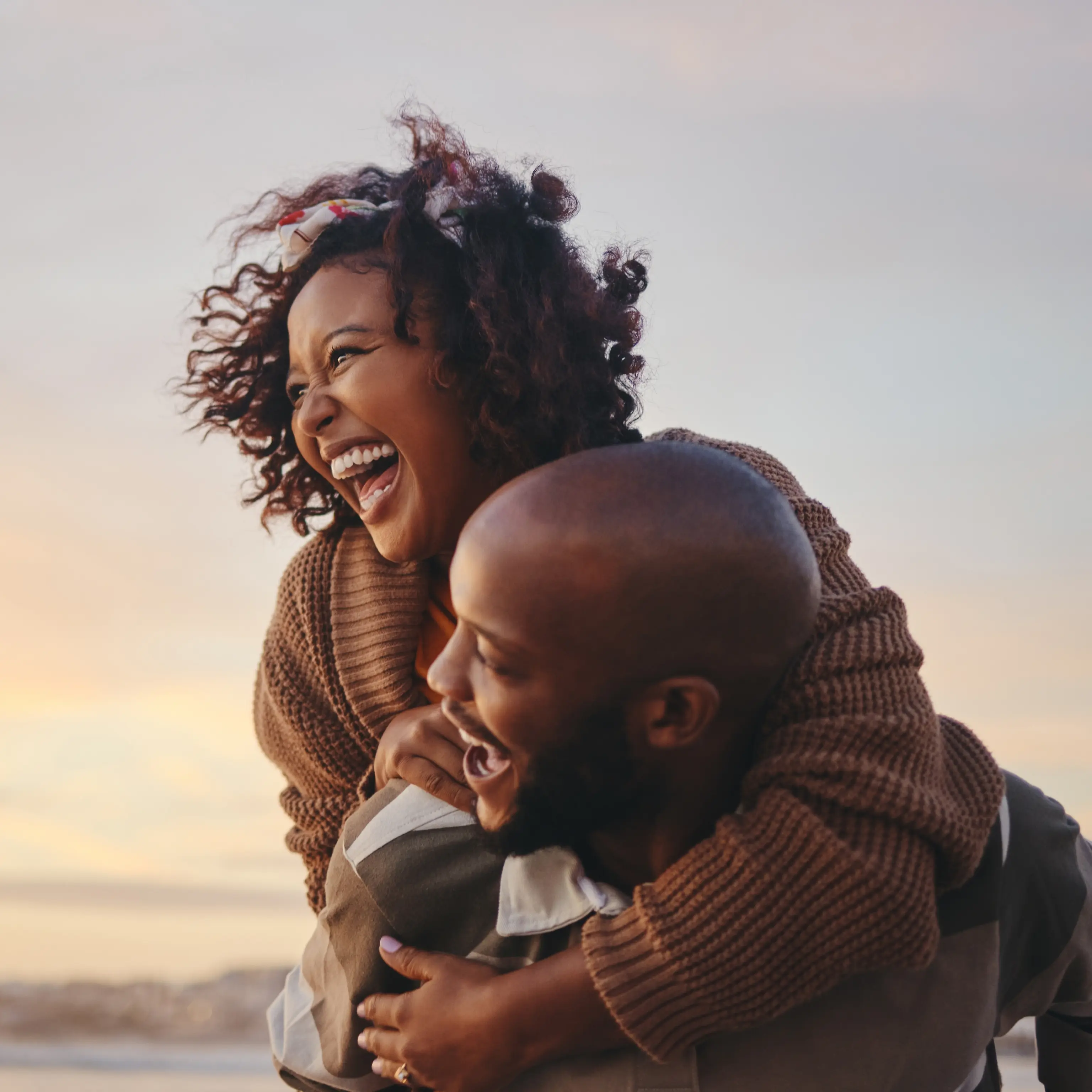 About-Harborstone.png Couple laughing together on a beach