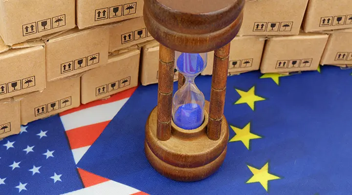 Reloj de arena encima de una bandera de la Unión Europea.