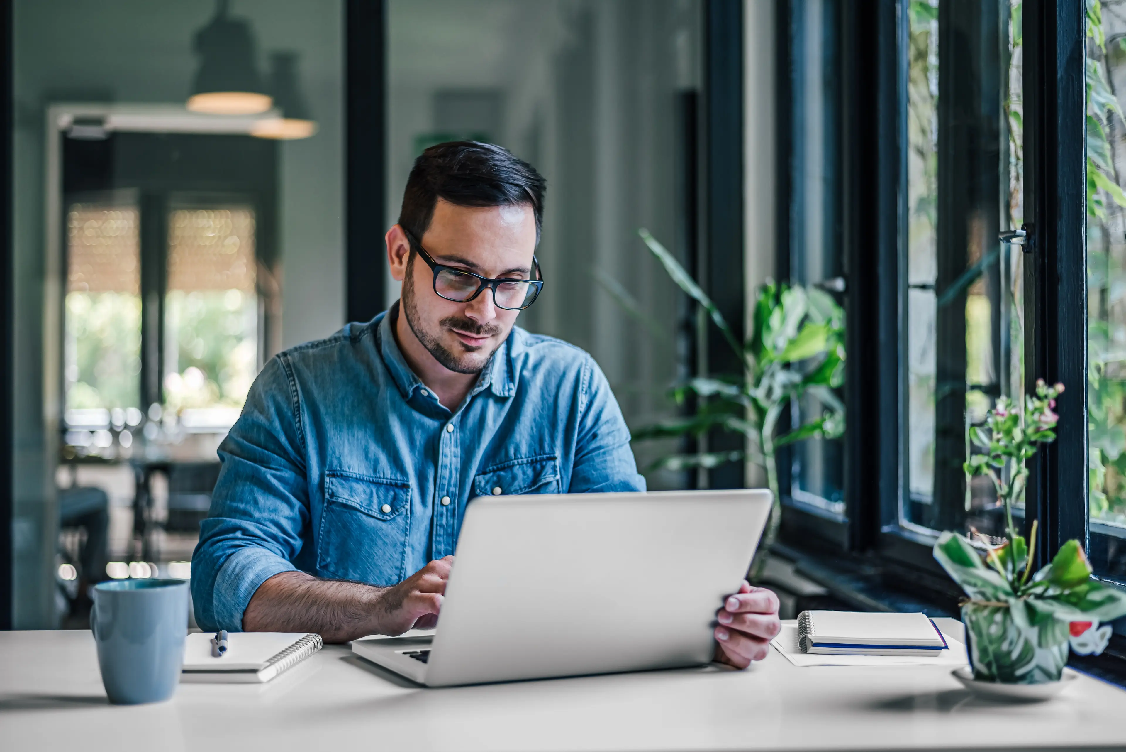 A man sitting and looking at the laptop