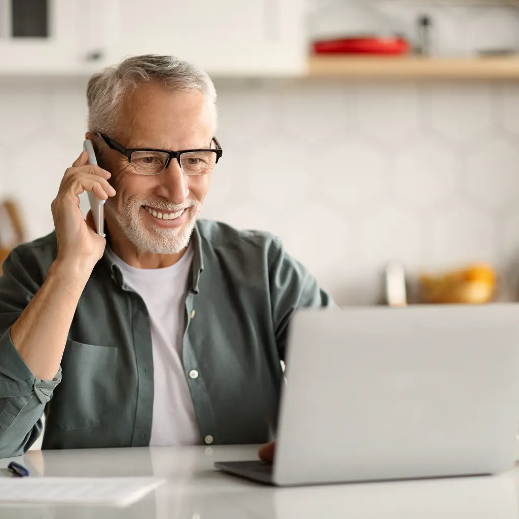 man on phone with laptop