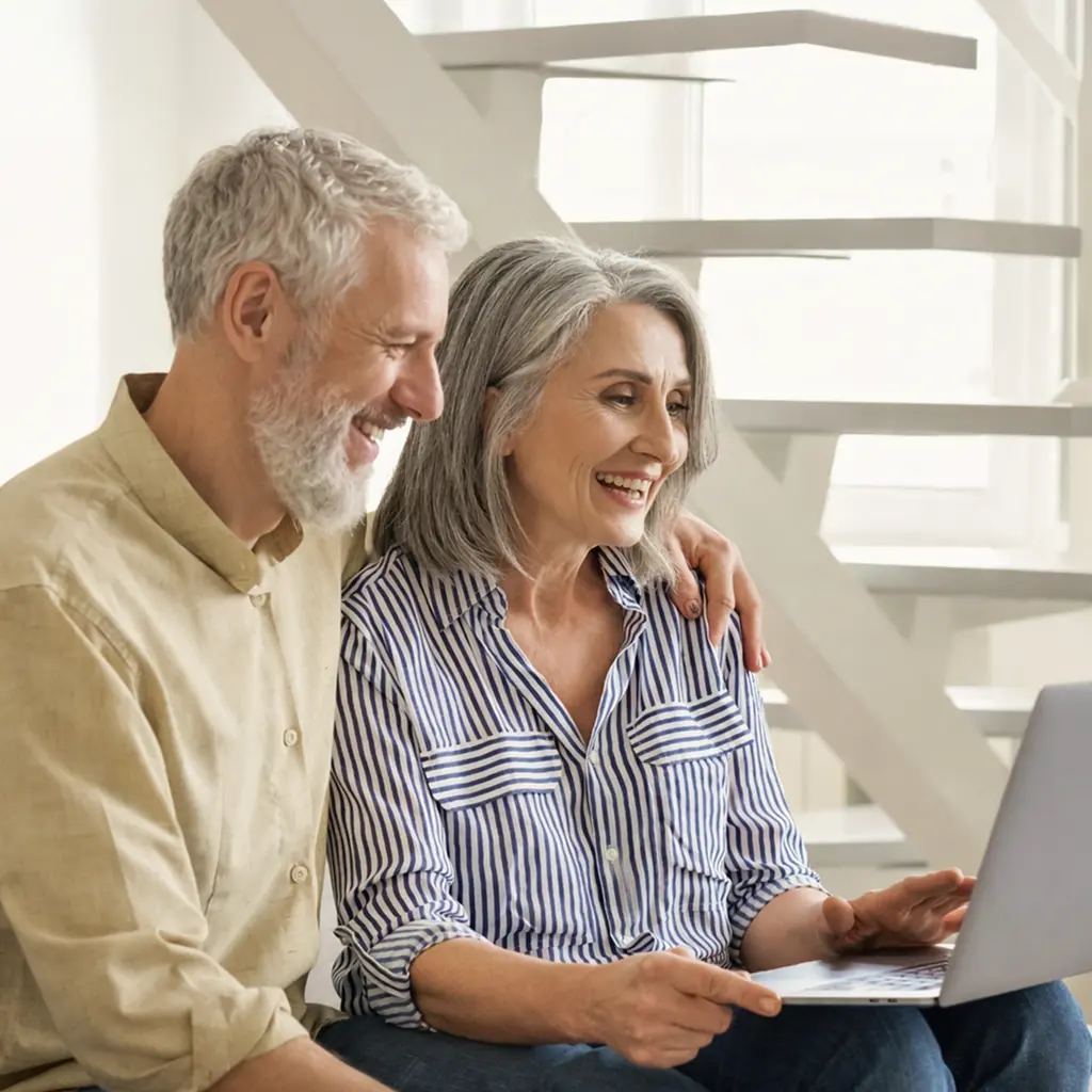 senior couple looking at laptop